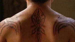Detailed tribal tattoo on bare upper back